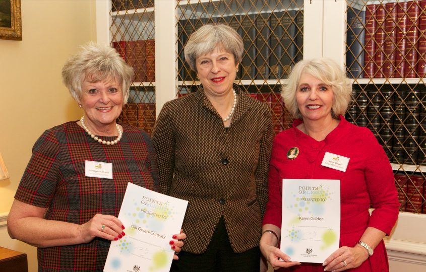 theresa may with the two receivers of the points of light award